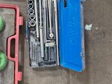 two green apples and a wrenet in a tool box