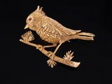 a gold bird sitting on top of a tree branch