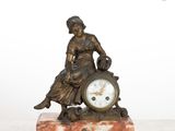 a statue of a woman sitting on top of a clock