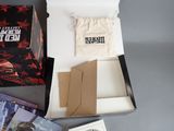 a box of books and a bag of cards on a table