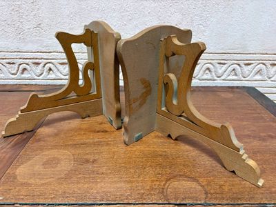 two wooden bookends sitting on a wooden table
