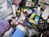 a pile of cosmetics and other items on a desk