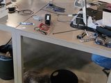 a desk with two computers and a monitor on it