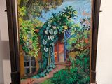 une peinture à l'huile représentant une maison dans un jardin, posée sur un chevalet