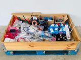 a wooden box filled with assorted items on the floor