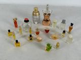 a lot of small bottles of perfume on a white surface