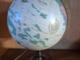 une lampe posée sur un globe, sur une table
