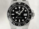 une montre Rolex avec un cadran noir et un bracelet en acier inoxydable