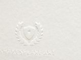 white paper with a heart and laurel emblem on it