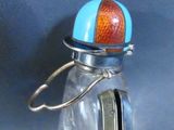 a small glass jar with a blue and red ball inside of it