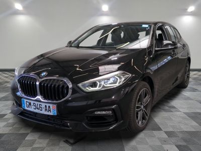 the bmw x1 is parked in a showroom with a checkered floor