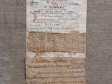 an old piece of paper with writing on it sitting on a piece of cloth