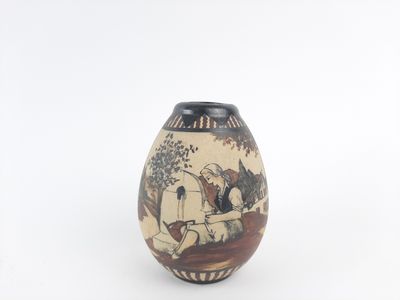 a small vase with a painting on it on a white surface