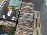 a lot of records in a box on the floor