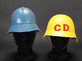 two hard hats that are sitting on top of a mannequin head