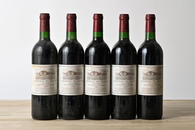 six bottles of wine are lined up on a wooden table