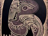 a black and white drawing of a woman ' s face on a black background