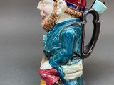a figurine of a man with a pipe in his hand
