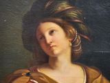 an oil painting of a woman holding a bird in her hand