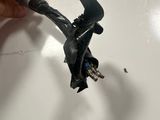 a person that is holding a piece of wire in their hand