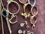 many different types of jewelry on a purple cloth