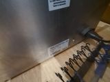 a metal box with springs attached to it on a wooden table