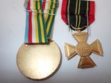 two medals and a medal on a table