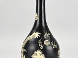 black and white vase with a dragon design on it