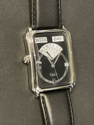 a black watch with a silver face on a black leather strap