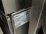 a close up of a stainless steel refrigerator with a label on it