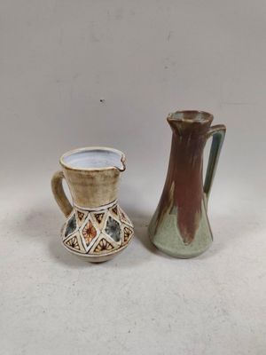 two vases sitting next to each other on a table