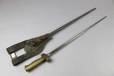 two old tools that are sitting on a white surface