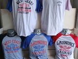 several t - shirts are displayed on a shelf in a clothing store