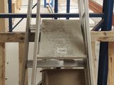 a ladder that is sitting in the middle of a room