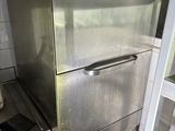 a stainless steel refrigerator in the corner of a kitchen