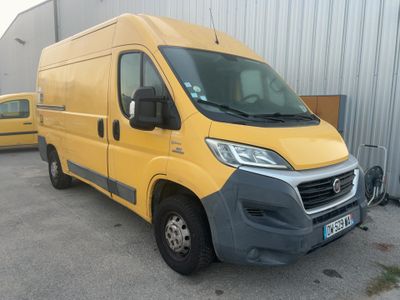 the yellow van is parked in front of a building