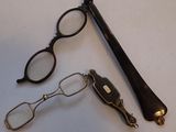 a pair of glasses, a pen, and a pair of glasses on a table