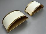 two white and gold napkin holders on a gray surface