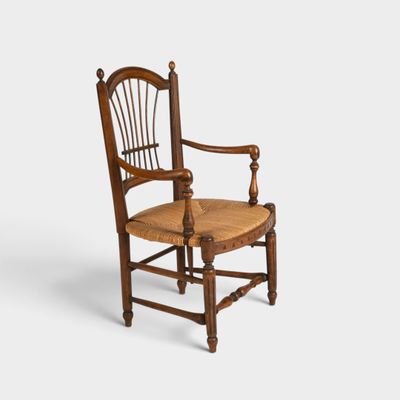 an old wooden chair with a cane back and seat on a white background