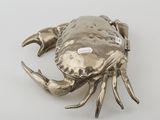 a silver crab that is sitting on a table