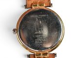 a close up of a wrist watch with a picture on it