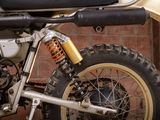 a motorcycle that is parked in front of a brick wall