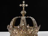a gold crown sitting on top of a white table