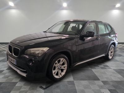 a picture of a black bmw suv parked in a garage