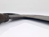 a pair of old tools sitting on a white surface