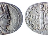 a close up of two silver coins on a white surface