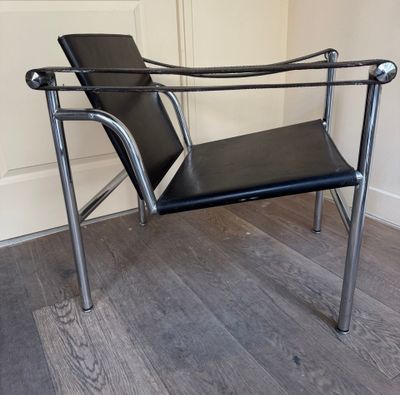 a black chair that is sitting on a hard wood floor