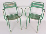 pair of green metal chairs on white background with white background