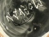 a close up of a black and white bowl with writing on it