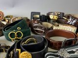 a lot of belts that are sitting on a table